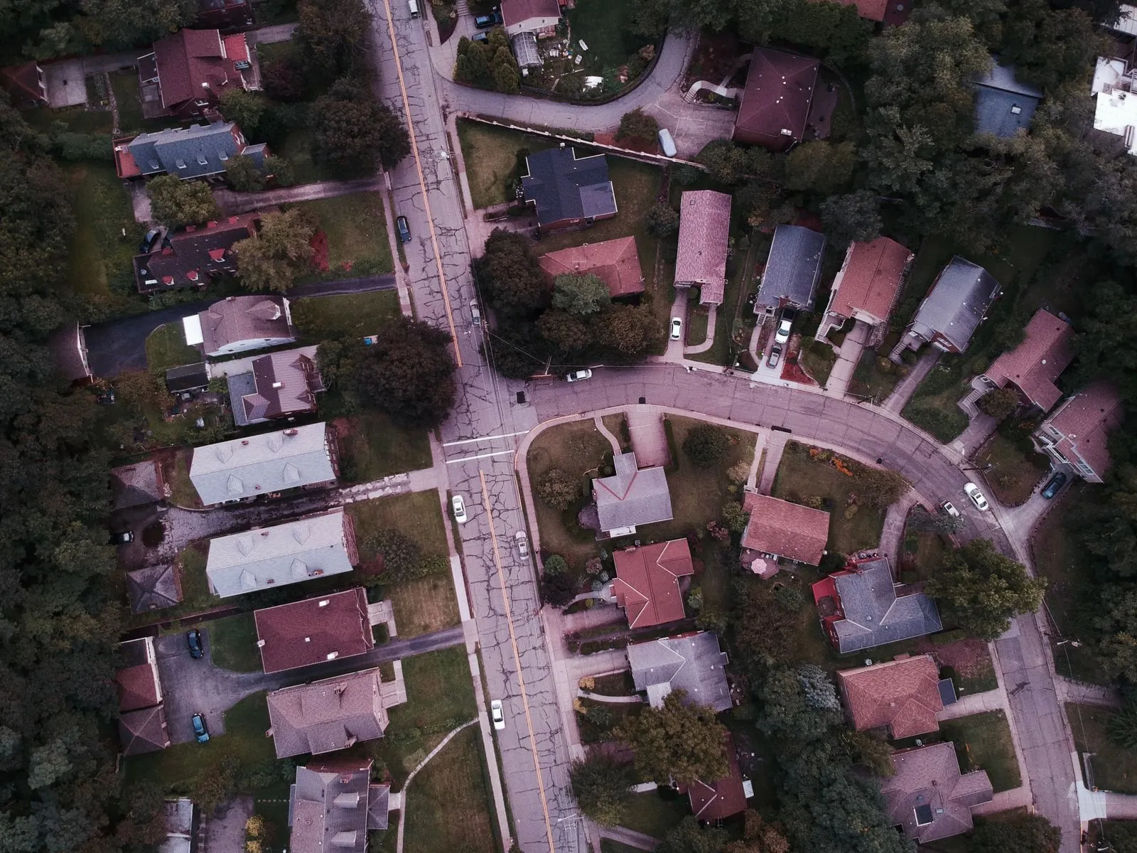 Top-down drone view of a suburban residential tract — streets, homes, and a cul-de-sac.